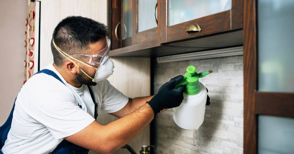 Pest control technician treating a home in West Jordan, UT